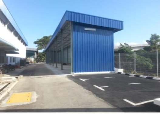 Completed industrial building with paved apron and car park