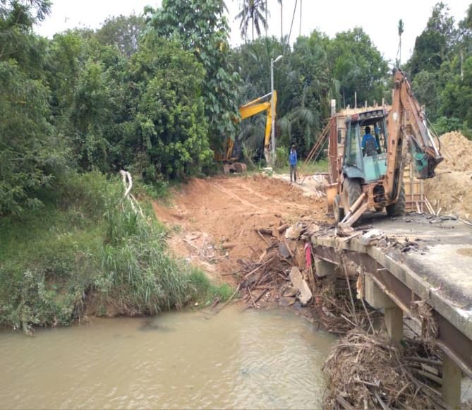 Excavator working in a river channel during bank repair