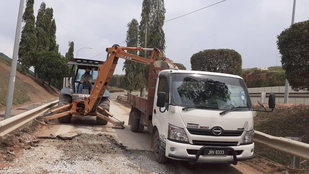 Backhoe loader and tipper lorry belonging to Pretech Construction