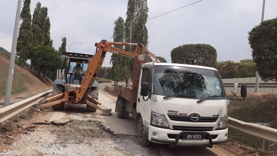 Backhoe loader and tipper lorry belonging to Pretech Construction