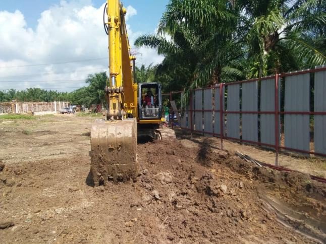 Excavation and pipe-laying on a housing scheme site.