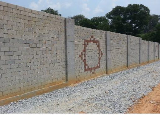 Completed concrete block boundary wall with decorative panel
